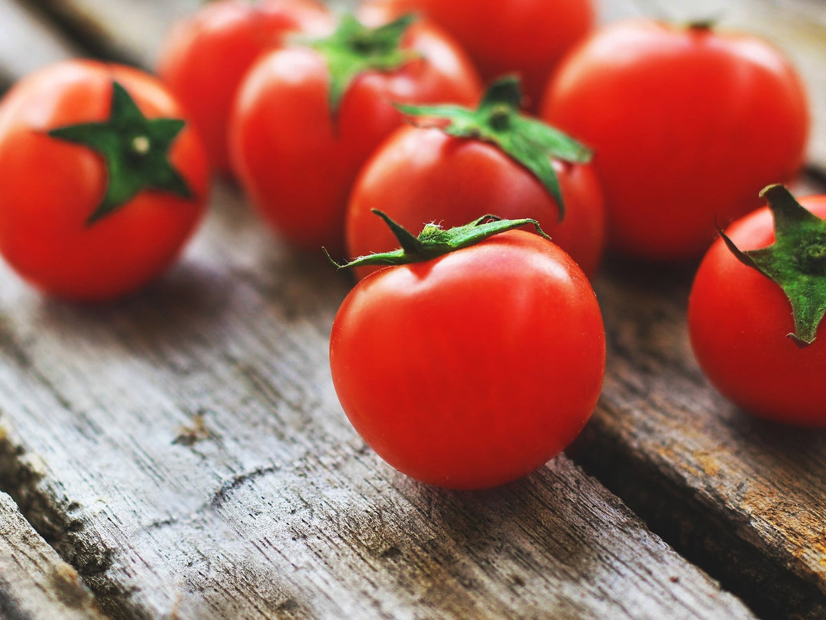 Freshly Grown Tomatoes On Wooden Table Top